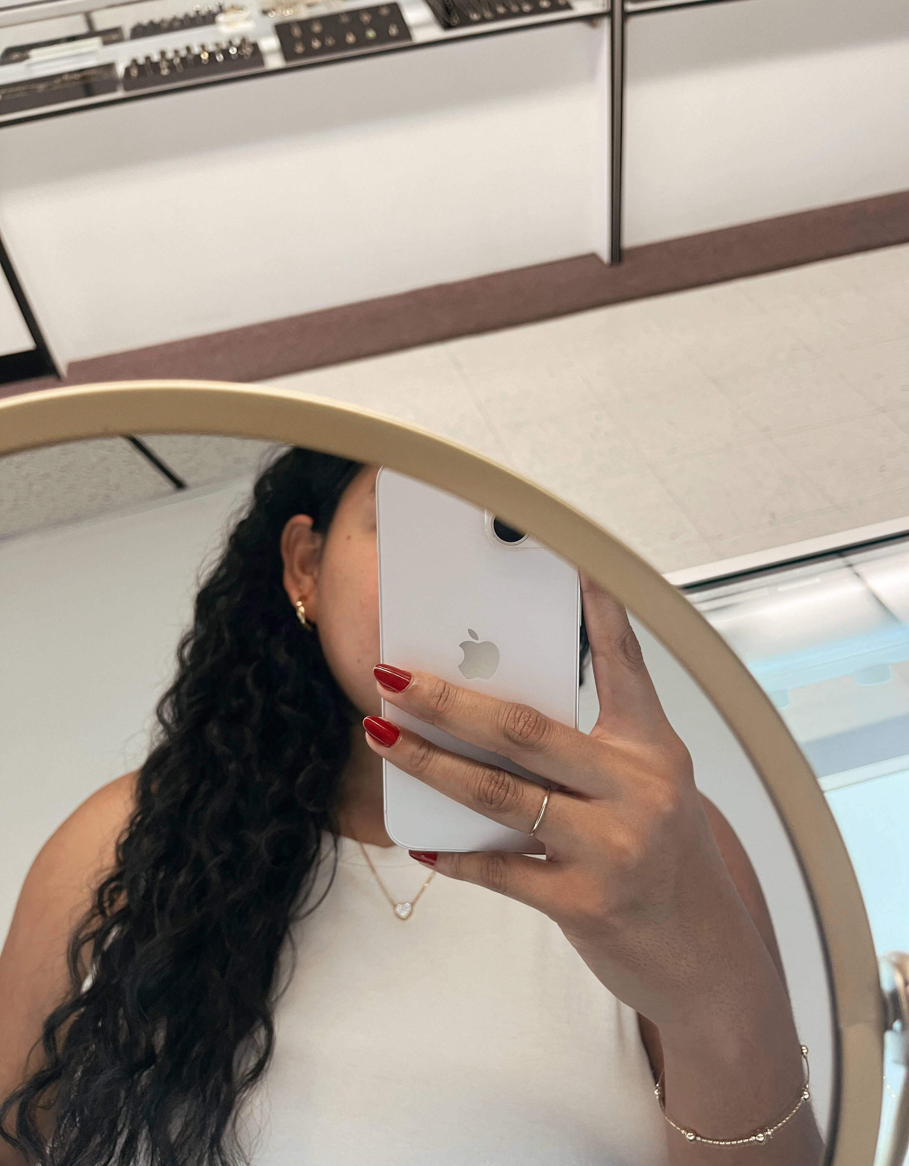 image of a woman taking a selfie photo in a mirror in a jewelry store