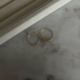 image of two gold hoops on a marble table