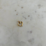 image of a gold heart pendant on top of a marble backdrop 