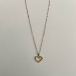 image of a heart gold pendant with a three color gold singapore chain with a white backdrop