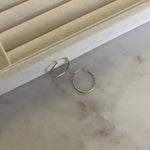 image of two earrings on the marble table against a ring tray