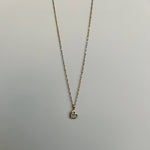 image of a heart pendant with a three tone rope singapore chain against a white backdrop